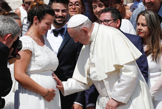 Pope Francis blesses the womb of a pregnant woman during his general audience in St. Peter's Square at the Vatican June 5, 2019. In a message sent May 12, 2022, to participants of a conference in Rome, Pope Francis said declining birth rates in Italy and Western countries are "impoverishing everyone's future."
