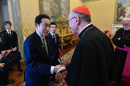 Japanese Prime Minister Fumio Kishida greets Cardinal Pietro Parolin, Vatican secretary of state, after his audience with Pope Francis at the Vatican May 4, 2022. The Vatican press office said the pope and the prime minister discussed the "war in Ukraine, stressing the urgency of dialogue and peace and expressing the hope, to this end, for a world free of nuclear weapons."