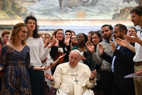Pope Francis and members of the "Political Fraternity" project of the Chemin Neuf lay movement pray together at the end of an audience May 16, 2022, in the Clementine Hall of the Apostolic Palace at the Vatican.