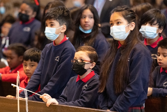 From left, first-grader Leo Vega, fifth-grader Immanuel Rowland, first-grader Ian Montano Alaron and fifth-grader Camila Lopez listen during Mass April 21 at Risen Christ Catholic School.