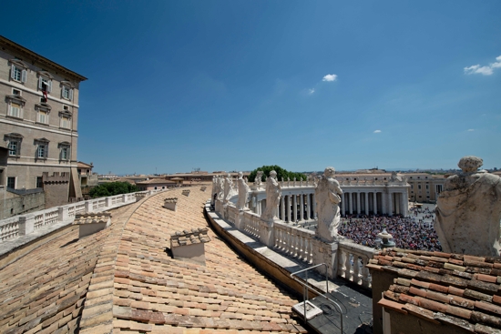 Pope Francis leads the Angelus from the window of his studio, left, overlooking St. Peter's Square at the Vatican June 19, 2022.