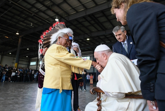 Pope Francis kisses the hand of residential school survivor Alma Desjarlais of the Frog Lake First Nation during a welcoming ceremony at Edmonton International Airport July 24, 2022. The pope was beginning a six-day visit to Canada. CNS photo/Vatican Media