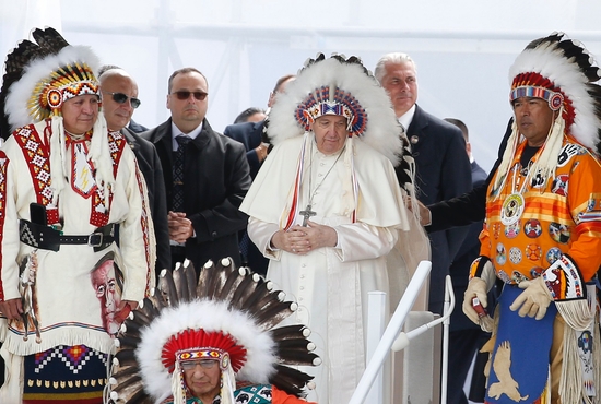 Pope Francis wears a traditional Indigenous headdress during a meeting with First Nations, Métis and Inuit communities at Maskwacis, Alberta, July 25, 2022.