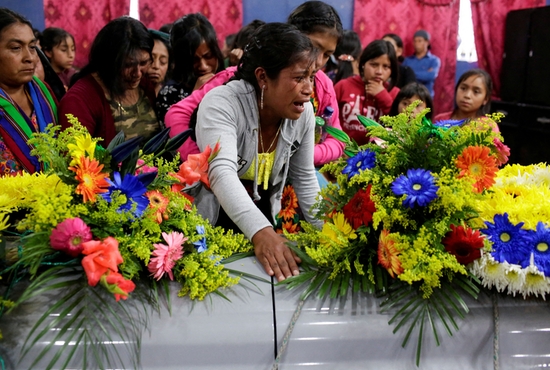 Isabela Guachiac, an aunt of Pascual Melvin Guachiac, 13, who died June 27, 2022, when he suffocated while being smuggled in a semitrailer in San Antonio, cries during the funeral of her nephew in the small village of Tzucubal in Nahuala, Guatemala July 16, 2022. The teen was one of 53 migrants found dead in the truck's cargo area.