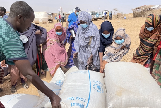 People receive bags of relief grains at a camp for the internally displaced people in Adadle, Ethiopia, Jan. 22, 2022. A continuing siege of Tigray by Ethiopian government forces is frustrating church efforts to deliver humanitarian aid to millions of people in need, a local priest has reported.
