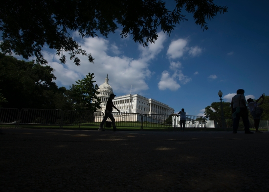 People are seen near the U.S. Capitol in Washington June 24, 2022. In bipartisan vote July 26, U.S. House overwhelmingly passes new legislation to combat human trafficking.