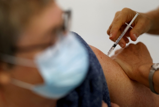 A medical worker administers a dose of the COVID-19 vaccine to a patient Nov. 17, 2021.