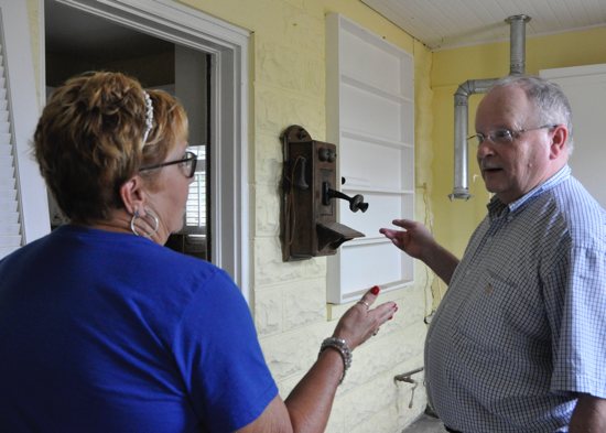 Barbara Hooper, vice president and flood relief coordinator of the Society of St. Vincent de Paul conference at St. Patrick Church in McEwen, Tenn., speaks with Ted Rice in McEwan in this undated photo. Hooper described the work St. Vincent de Paul plans to do on his home, which was severely damaged by the Aug. 21, 2021, flash floods in Humphreys County.