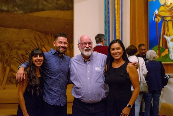 Jesuit Father Greg Boyle, founder of Homeboy Industries in Los Angeles, center, poses for a photo with Fully Liberated Youth co-founders Natalie Baddour and Preston Adams, left, and Francine Adams, Preston's wife, at Jesuit-run Regis University in Denver Sept. 9, 2022. 