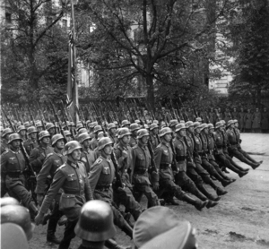 German troops march through Warsaw, Poland, in September 1939. The Polish bishops' conference has cautiously endorsed government demands for $1.29 trillion reparations from Germany for World War II damage.
