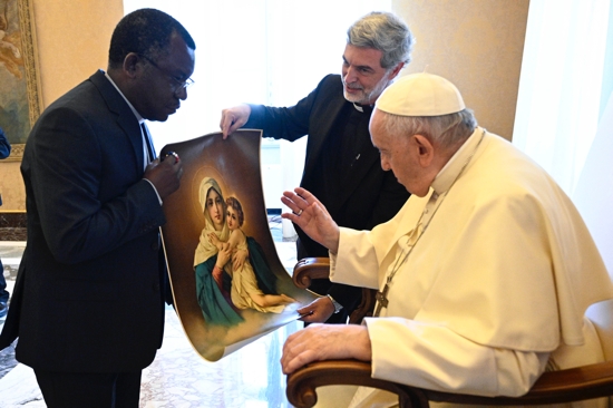 Pope Francis blesses an image of Mary and the Christ Child during a meeting with Schonstatt Fathers at the Vatican Sept. 1, 2022. At the pope's right is Schonstatt Father Alexandre Awi Mello, superior general of the Schonstatt Fathers and secretary for the Dicastery for Laity, the Family and Life. The priests were in Rome for their general chapter.