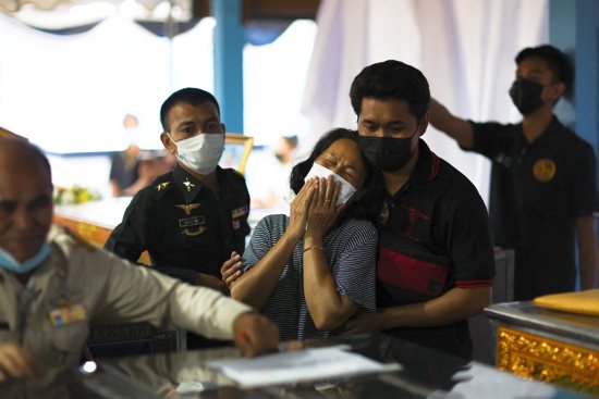 A woman reacts after identifying the body of a loved one at Sri Uthai temple in Na Klang, Thailand, Oct. 7, 2022, following of a mass shooting in Uthai Sawan. A former police officer facing a drug charge burst into the day care center Oct. 6, killing more than 30 people, including preschoolers, in the deadliest rampage in the nation's history. 