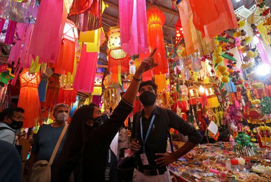 People shop for lanterns at a market in Mumbai, India, Oct. 28, 2021, ahead of Diwali, the Hindu festival of lights, which this year begins Oct. 24 in most countries. 