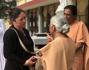 Marta Pereira, left, speaks to two Sisters of St. Joseph of Cluny outside their convent in Vandiperiyar, India, while leading a mission trip to the Diocese of Vijayapuram in 2019.
