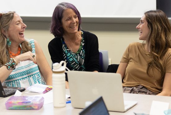 Instructor Lucy Payne, center, talks with students Julie Steege, left, and Nikki Gibbs, right, during class Sept. 20 at the Murray Institute at the downtown Minneapolis campus of the University of St. Thomas. Steege is a teacher at Annunciation Catholic School in Minneapolis, and Gibbs is a teacher at St. Michael Catholic School in St. Michael. Payne is an associate professor in UST’s School of Education.
