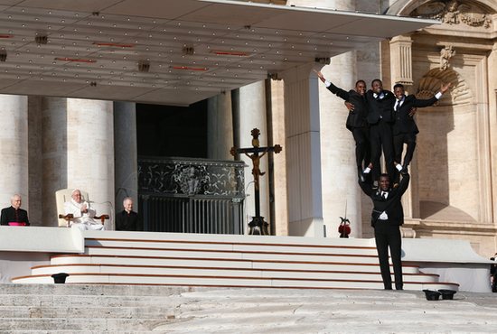 Pope Francis watches as a group of five Kenyan acrobats perform as the Black Blues Brothers during his general audience in St. Peter's Square at the Vatican Nov. 30, 2022. CNS photo/Paul Haring
