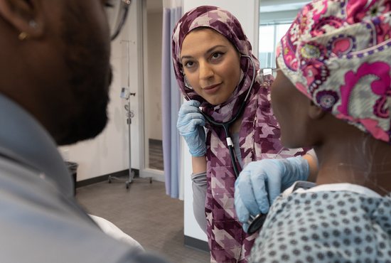 Sarah Abuisnaineh, a graduate student in the School of Nursing at the University of St. Thomas, practices clinical skills on a mannequin along with fellow student Christopher-Jerell Edwards Nov. 16 in a classroom at the Morrison Family College of Health on the St. Paul campus.