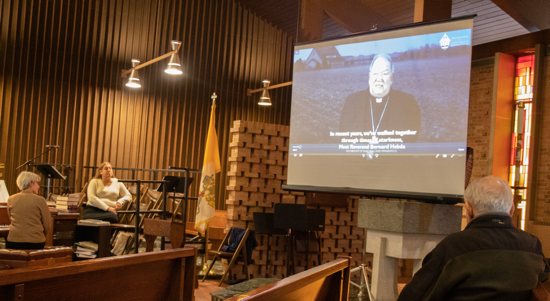 Kathryn Lien at the piano, Jennifer Strei, cantor, and Leo Mudek view the video of Archbishop Hebda introducing his post-synodal pastoral letter just before Mass Nov. 20 at Presentation in Maplewood.