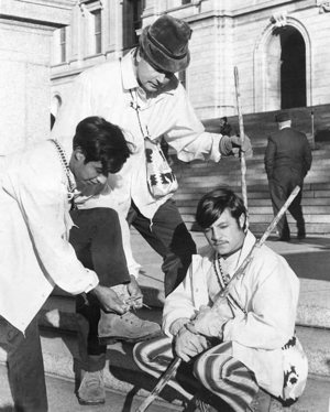 Father Greg Schaffer, later Msgr. Schaffer, with Elias Jacinto, lacing up a shoe, and Ronal Motta, who later was among 40,000 other Guatemalans who “disappeared” in that country’s 36-year civil war, as they began their 1972 walk from the State Capitol in St. Paul to Guatemala.