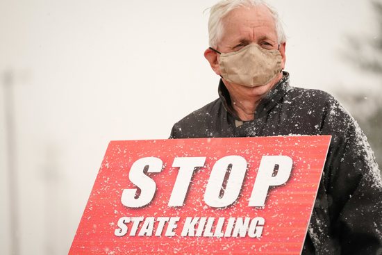 A protester against the death penalty is seen in this file photo. By executive action, Oregon Gov. Kate Brown commuted the sentences of 17 people on death row to life imprisonment without the possibility of parole Dec. 13, 2022.