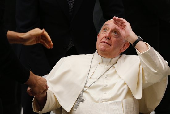 Pope Francis looks up as he greets people during his general audience in the Paul VI hall at the Vatican Dec. 14, 2022. 
