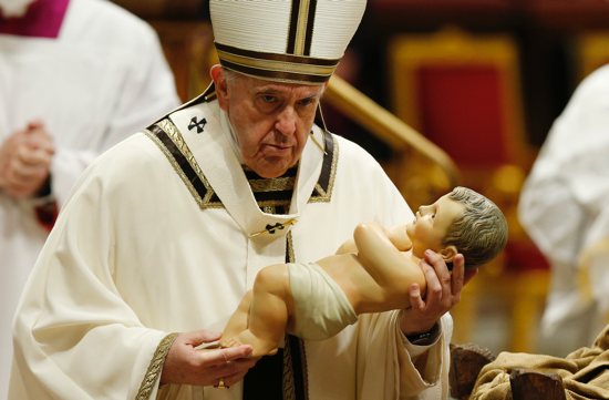 Pope Francis carries a figurine of the baby Jesus at the conclusion of Christmas Eve Mass in St. Peter's Basilica at the Vatican in this Dec. 24, 2021, file photo. With the removal of most of the restrictions of the COVID-19 pandemic, the pope is scheduled to return to a full slate of public liturgies in December and January. 