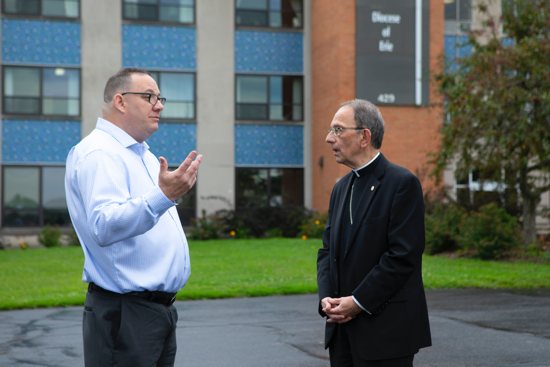 Bishop Lawrence T. Persico of Erie, Pa., speaks with Jim VanSickle of Pittsburgh, who told a Pennsylvania grand jury he was molested by a priest when he was a teenager in Bradford, Pa. VanSickle and the bishop spoke during an Aug. 21, 2018, news conference held in front of the Diocese of Erie's headquarters by members of the Survivors Network of those Abused by Priests, or SNAP.