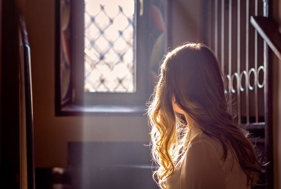 Teenager praying in church