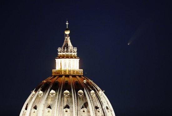 The comet "Neowise" is seen in the sky behind the dome of St. Peter's Basilica in Rome July 13, 2020.