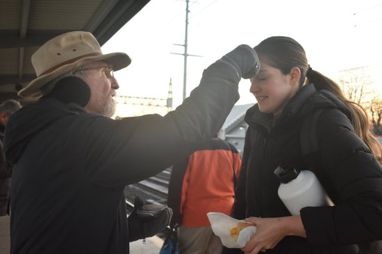 Father Peter Adamski, pastor of St. James Parish in Stratford, Conn., imposes ashes on a commuter's forehead on Ash Wednesday, Feb. 22, 2023. Father Adamski offers ashes to commuters every Ash Wednesday at the Stratford Metro North train station, just half a mile from his home parish.