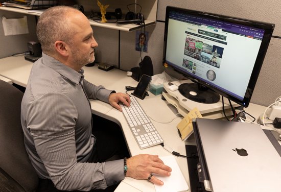 Michael Pytleski, website and social media coordinator at The Catholic Spirit, puts final touches on the newspaper’s improved website, TheCatholicSpirit.com.