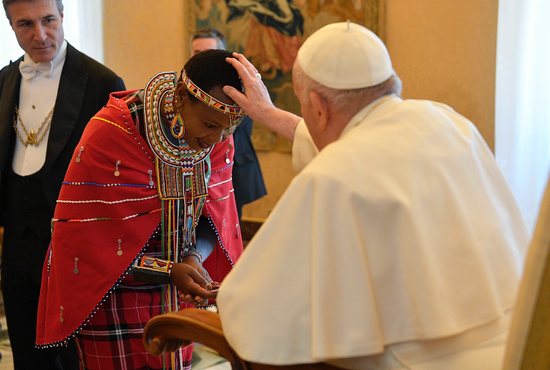 Pope Francis blesses a participant from the International Fund for Agricultural Development's Indigenous Peoples' Forum during an audience at the Vatican Feb. 10, 2023.