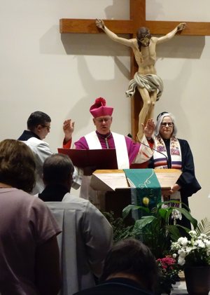 Bishop Kevin C. Rhoades of Fort Wayne-South Bend, Ind., offers a closing prayer at a Jewish-Catholic interfaith prayer service Nov. 20, 2019, at St. Elizabeth Ann Seton Catholic Church in Fort Wayne. Standing beside the bishop is Rabbi Paula Jayne Winnig, clergy leader of Congregation Achduth Vesholom in Fort Wayne and co-leader of the service. 