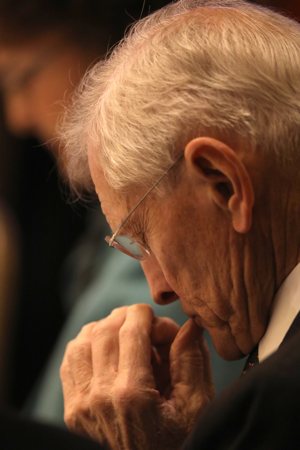 A man bows his head during the National Catholic Prayer Breakfast in Washington March 14, 2023.