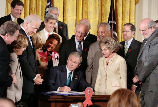 Then U.S. President George W. Bush signs a bill that extends the President’s Emergency Program for AIDS Relief, known as PEPFAR, in the East Room of the White House in Washington July 30, 2008.