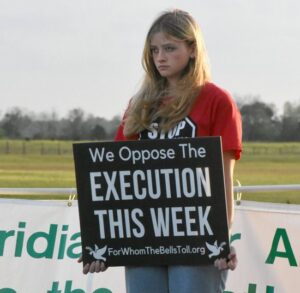 A student from Lourdes Academy Catholic School in Daytona Beach, Fla., stands for life in front of the Florida State Prison in Raiford Feb. 23, 2023, the day Donald Dillbeck was executed by lethal injection. Florida Gov. Ron DeSantis signed a bill into law April 20 that removes a requirement that juries be unanimous in recommending the death sentence.