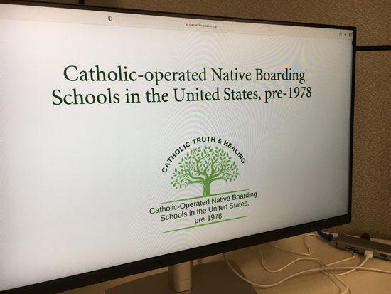 A photo shows the opening page of an online list of roughly 87 Native American boarding schools affiliated with the Catholic Church.