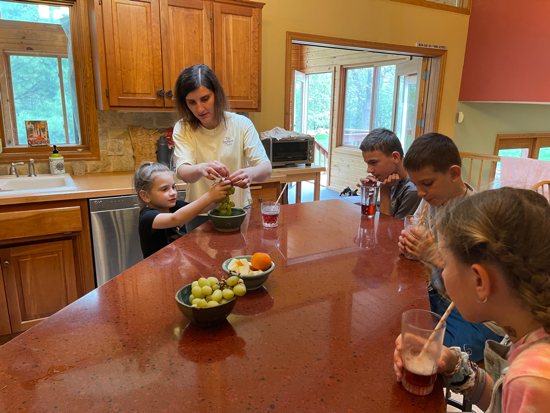 Maryna Topchii prepares after-school snacks for her two children and the two children of her cousin
