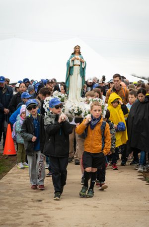 Children and adults wait for a two-mile "Walk with the Children" pilgrimage to begin at the National Shrine of Our Lady of Champion in Champion, Wis., May 6, 2023. Organizers of Walk to Mary, a 21-mile trek, began a walk for children in 2014 to allow more families to participate in the annual event.