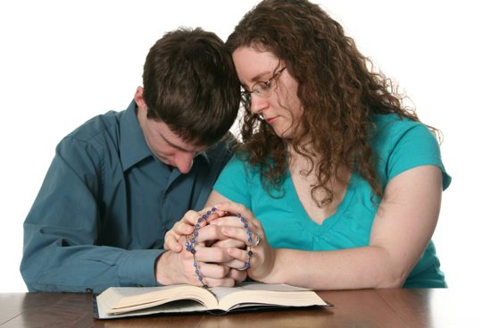 Couple praying rosary