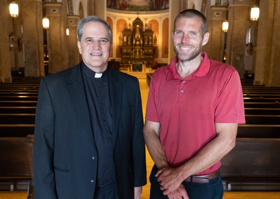 Colin Miller, right, hopes to spread the thought and practice of Catholic social teaching through the Center for Catholic Social Thought, which he founded. It is an initiative of Assumption in St. Paul, where Miller works as director of pastoral care and outreach. Supporting the effort is Father Paul Treacy, left, pastor of Assumption.