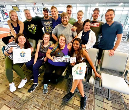 Young adults from the Archdiocese of St. Paul and Minneapolis get ready to board a plane headed for Portugal and World Youth Day.