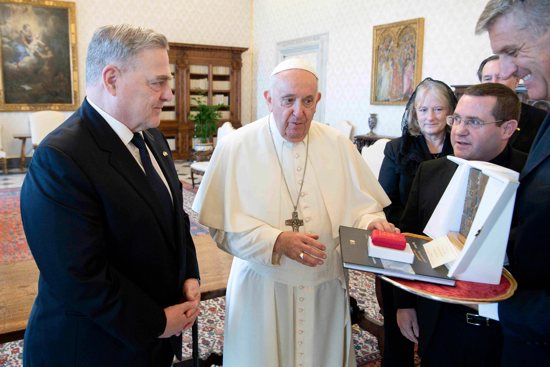 Pope Francis gives U.S. Gen. Mark A. Milley, chairman of the Joint Chiefs of Staff, a sculpture that says, "Peace is a fragile flower," during a meeting at the Vatican Aug. 21, 2023.