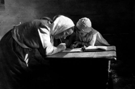 Wiktoria Ulma is pictured writing at a table with her oldest daughter, Stasia. The Ulma family secretly hid eight Jews for almost two years in German-occupied Poland during the Second World War. The Nazis killed the family and the Jews they were sheltering early in the morning March 24, 1944. The Vatican declared the Ulma family martyrs Dec. 17, 2022, and they will be beatified Sept. 10, 2023.
