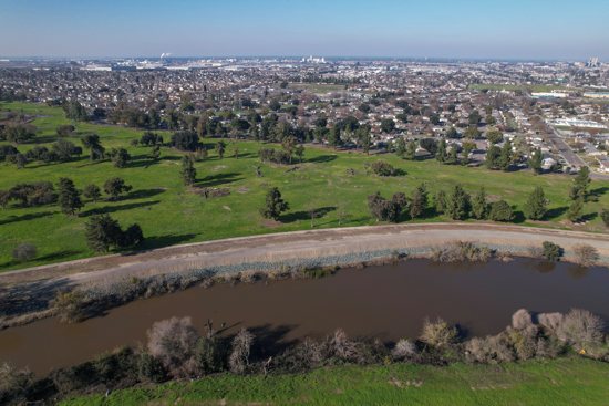 The Walker Slough, an offshoot of the San Joaquin River, is seen running alongside Van Buskirk Park in Stockton, Calif., Jan 26, 2023. Environmental groups hope the former municipal golf course will be converted into a restored floodplain.