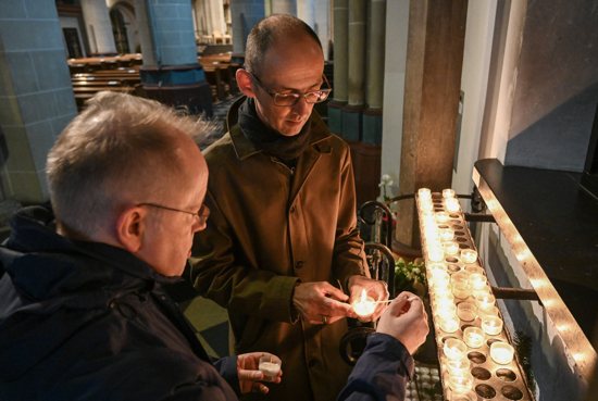 A gay couple light votive candles at a Catholic church in Essen, Germany, Oct. 30, 2021. Several hundred people gathered Sept. 20, 2023, near the cathedral in Cologne, Germany, to hold blessing service for LGBTQ+ people and people who remarried after divorce.