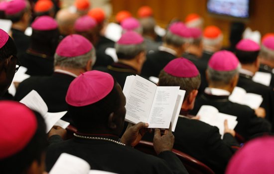 Bishops pray at the start of a session of the Synod of Bishops at the Vatican Oct. 9, 2018.