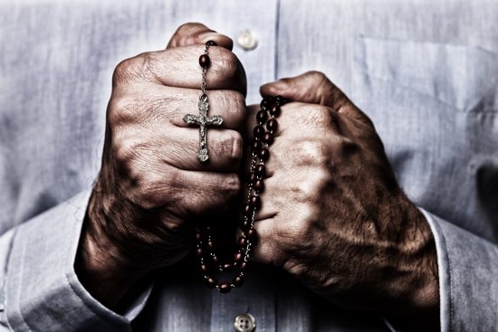 Man praying rosary