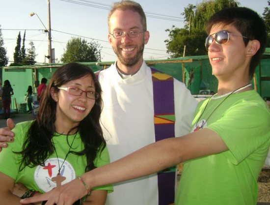 Father Mark Niehaus smiles with two young people who were part of the confirmation process at missions in Ahlue, Chile, in 2010.