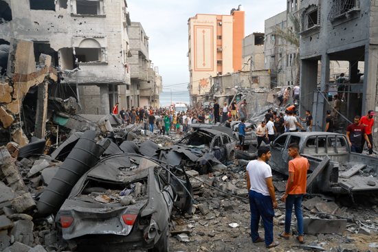 Palestinians inspect damages in the aftermath of Israeli strikes, following a Hamas surprise attack at Beach refugee camp, in Gaza City, Oct. 9, 2023. The Hamas-Israel war has entered a new phase, with more than 1,100 dead. Meanwhile pilgrims from all over the globe are in the Holy Land, with countries like Poland evacuating its citizens on military planes.